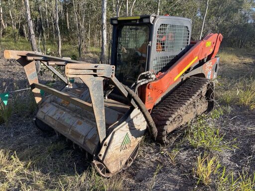 Cert 3 tree lopping arborist from Dynamic Tree Solutions using a skid steer to mulch a tree stump in New Beith.