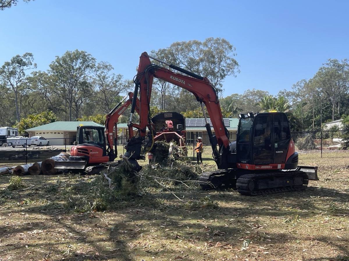 Two Kubota excavators clearing trees on an acreage block, Brisbane south side
